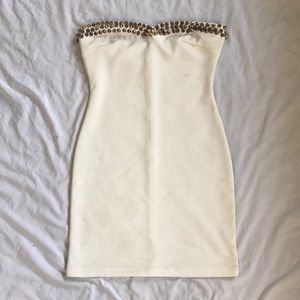 Gold, spike studded, strapless dress.